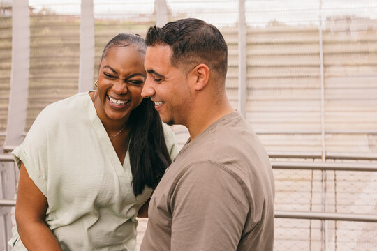 Curvy Dominican couple sharing a joyful moment outdoors