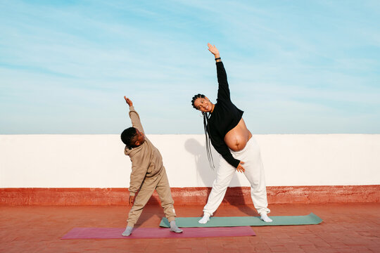 Pregnant mother and son working out
