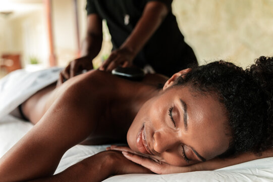 Woman enjoying a rejuvenating hot stone massage