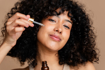 woman applying facial serum