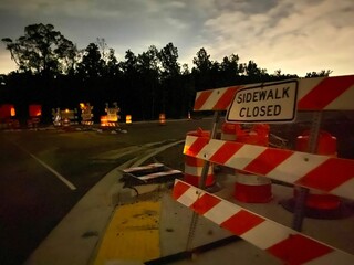 Sidewalk Closed Sign at Night, construction barriers, cloudy sky  © MCCreative