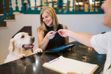 Woman and Dog at Hotel Check-In Counter