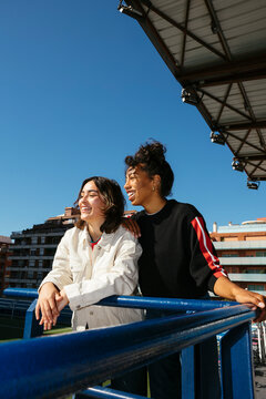 Joyful friends enjoying a sunny day at the stadium