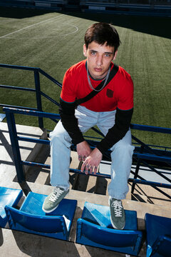 Man sports fan seated at stadium