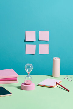  Desk setup with clock, paper, and miscellaneous office supplies