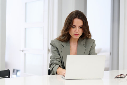 Serious worker using laptop