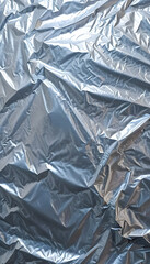 gray crumpled plastic paper textured background