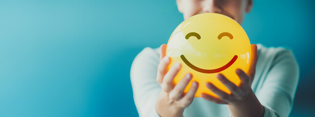 Woman hand holding happy smile sphere, Positive thinking, Mental health assessment , World mental health day concept