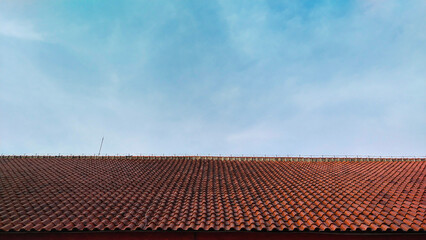 roof tiles of a building with a bright blue sky during the day