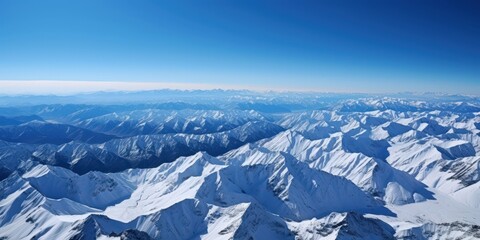 Fototapeta premium Aerial View of Majestic Snow-Capped Mountains