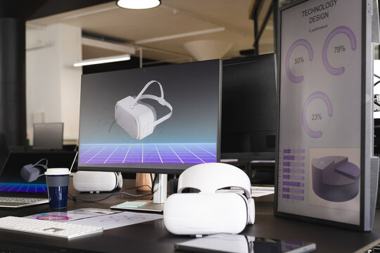 Using VR headsets, office workers developing technology design on computer screens