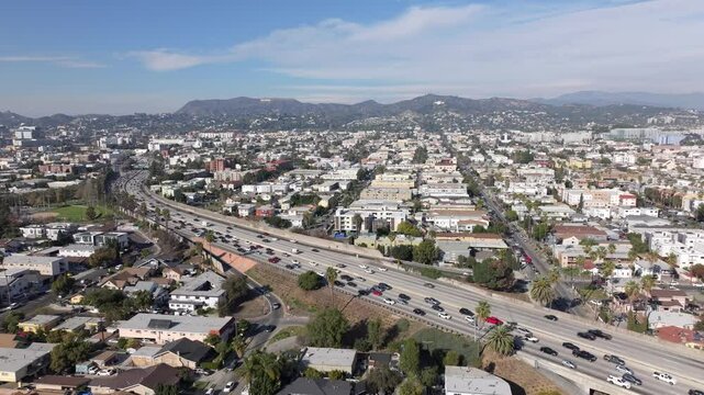 East Hollywood, California and US Route 101 - pullback aerial reveal at daytime