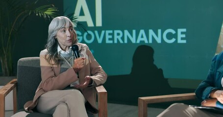 Conference, business women and speaker on stage with host for question, talk or speech at startup. Guest, technology and event at seminar for presentation on ai governance, policy or risk management