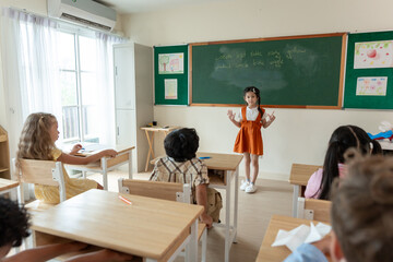 Asian young schoolgirl student dancing in front of classroom at school.
