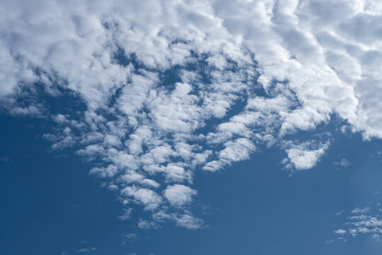 Image of Cirrocumulus stratiformis like fleece clouds in a sunny day with blue sky