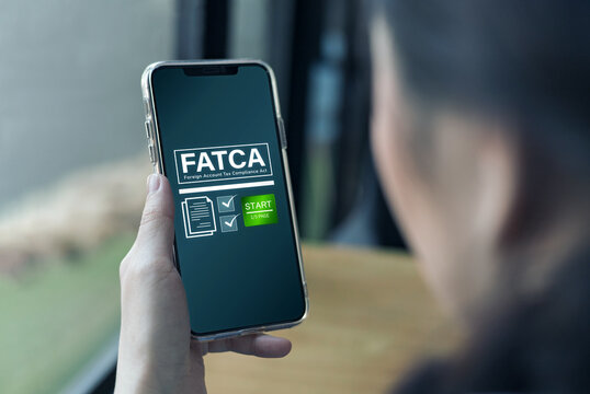 FATCA, Foreign Account Tax Compliance Act concept. Woman uses smartphone to take questionnaire. United States law for financial institutions Non-American citizens report financial accounts and taxes.