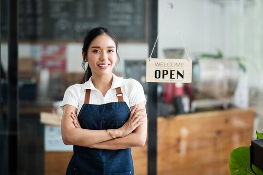 Startup successful small business owner sme beauty girl stand with arms crossed in coffee shop restaurant. Portrait of asian tan woman barista cafe owner SME entrepreneur seller business concept
