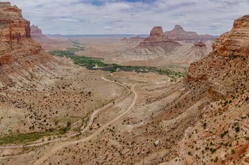 Dirt road going through a Canyon and tall Buttes. Buckhorn Wash, Utah, United States of America.