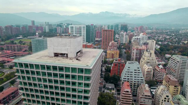 Aerial view around vibrant building, in cloudy Escuela Militar, Santiago de Chile