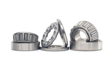 Tapered roller and thrust ball bearings isolated on white