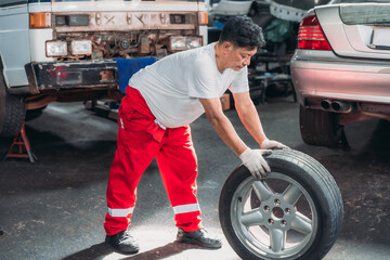 Mechanic Rolling Car Tire