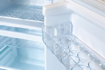 new modern refrigerator opens to reveal the inside, empty refrigerator