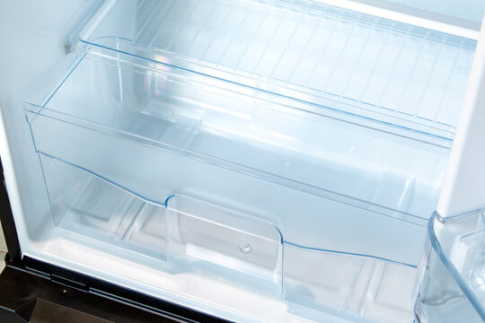 new modern refrigerator opens to reveal the inside, empty refrigerator