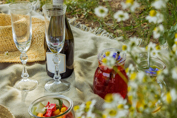 Beautiful white boho style decor. Picnic in nature on the grass under the tree