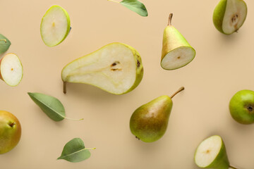 Flying ripe pears on beige background