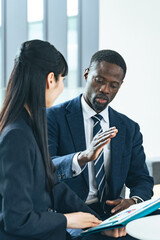 Group of multinational business people talking in a lobby