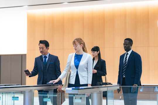 Group of multinational business people passing through a security gate