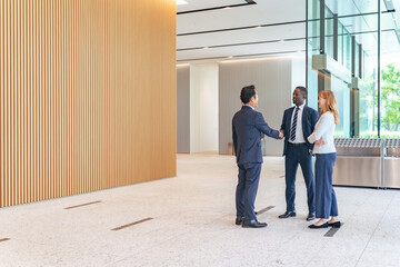 Group of multinational business people shaking hands in a lobby