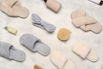 Slippers and body care supplies on white background. Top view