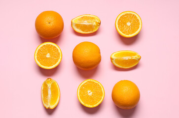 Fototapeta premium Beautiful composition with tasty oranges on pink background