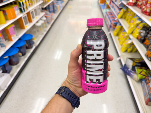 Hand holding a Prime X hydration drink inside a supermarket. On June 27, 2024 in Los Angeles, CA.