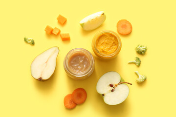 Composition with jars of healthy baby food and ingredients on yellow background