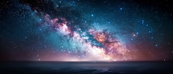 Obraz premium Stunning night sky with the Milky Way galaxy above a calm ocean, showcasing colorful stars and cosmic wonders in a serene and breathtaking scene.
