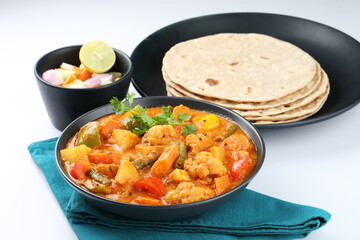 Mix vegetable curry - Indian main course recipe contains Carrots, cauliflower, green peas and beans, baby corn, capsicum served with Chapati