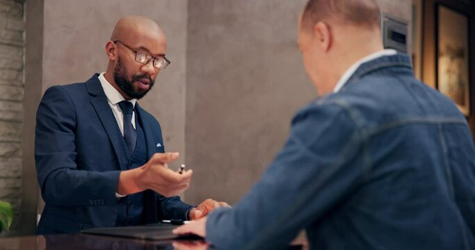 Hotel, employee and guest at reception for check in, hospitality and accommodation with documents. Signing, people and worker with luxury, industry and service with paperwork, concierge and tourism