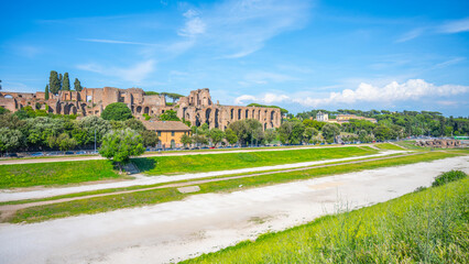 Fototapeta premium The Circus Maximus, Italian: Circo Massimo, an ancient Roman chariot-racing stadium and mass entertainment place in ancient Rome, Italy. With buildings of Palatine Hill on background