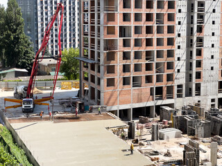 Complex construction of many storey residential buildings of reinforced concrete and bricks in the city