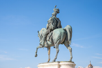 A bronze statue of Victor Emmanuel II, the first king of a unified Italy, stands on horseback in Rome. The statue is a prominent landmark in the city and is often visited by tourists.