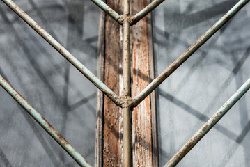 window with iron bars in an old prison close up
