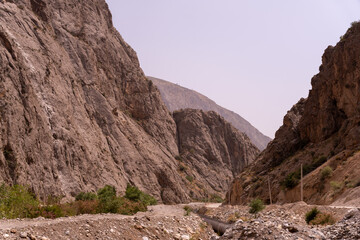 A rocky mountain range with a dirt road running through it