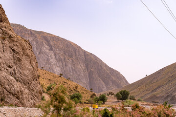 A mountain range with a yellow building in the distance
