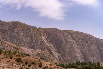 A mountain range with a cloudy sky in the background