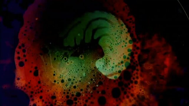 Multi-colored liquid light show effect with bubbles.