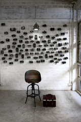Interior design idea by using the classic film cameras hanging on the white brick wall.
