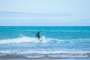 Fototapeta premium professional surfer riding waves, men catching waves in ocean, isolated. Surfing action water board sport. people water sport lessons and beach swimming activity on summer vacation