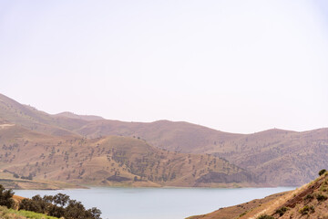 A mountain range with a lake in the foreground